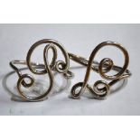 A pair of Russian 84 zol napkin rings of scrolling design,