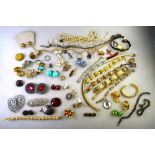 A mixed lot of vintage and later jewellery including necklaces, bracelets, paste clip,