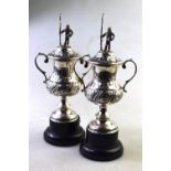 Two small silver trophy cups and covers, the finials modelled as anglers (Harrison Cup, River Dee,