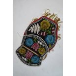 An Iroquois beaded velvet bag, decorated on both front and back with floral designs in blue, white,