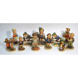 Eleven Goebel Hummel figures comprising: Little Hiker; Soloist; Singing Lesson; Barnyard Hero;