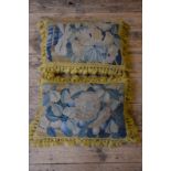 Two cushions made from antique wool tapestry with old gold tasseled fringing,