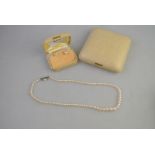 A graduated simulated pearl necklace with simulated pearl and paste set snap,