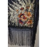 A 1920s black silk and gold thread fringed shawl with floral design, 124 x 130 cm (fringing 45 cm),