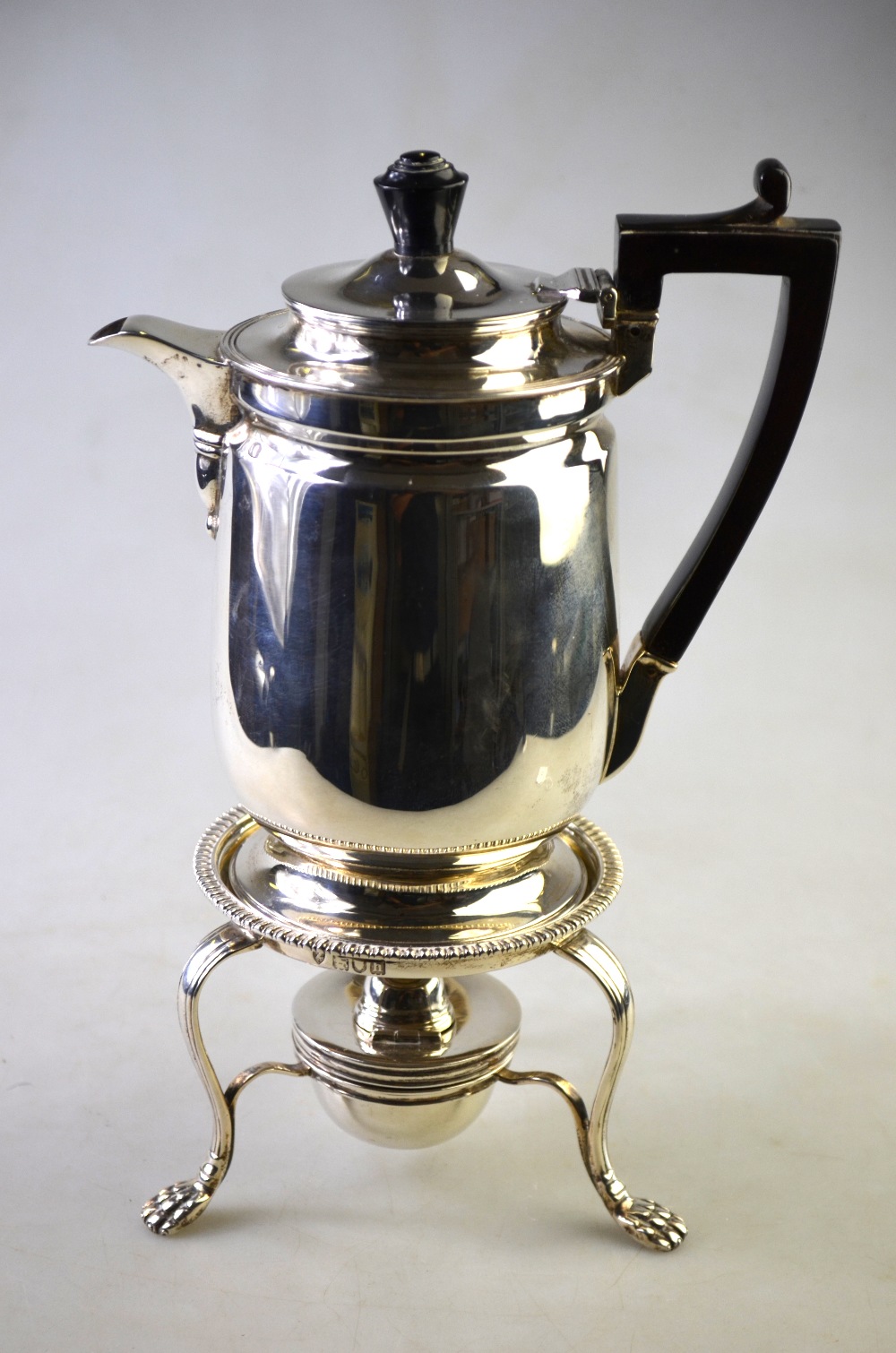 An Edwardian heavy quality silver hot water jug on stemmed foot with ebonised handle,