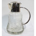 A heavy cut glass cocktail jug of waisted form, with electroplated collar, handle,