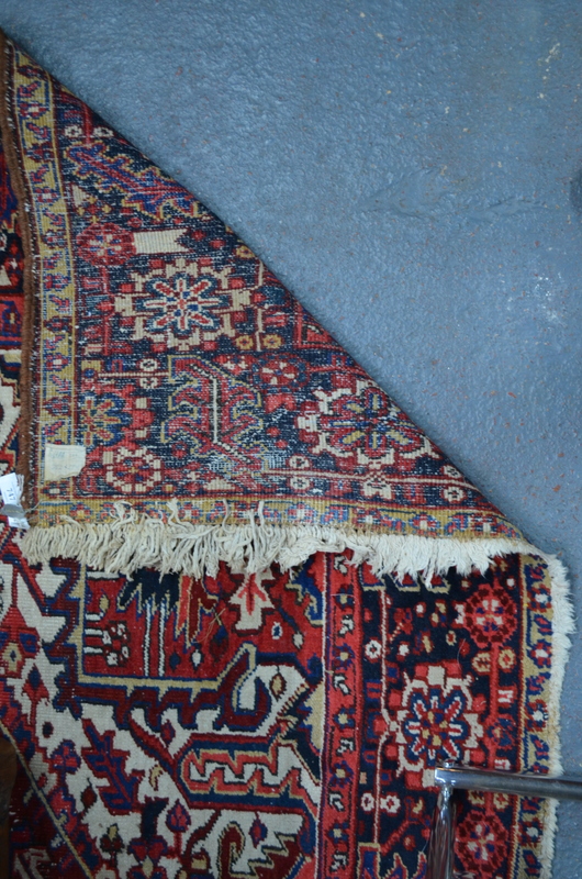 A Persian Heriz carpet, the large central blue medallion on red ground with stylised floral design, - Image 2 of 7