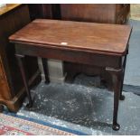 An 18th century Cuban mahogany tea table, the rectangular fold over top over a plain frieze,