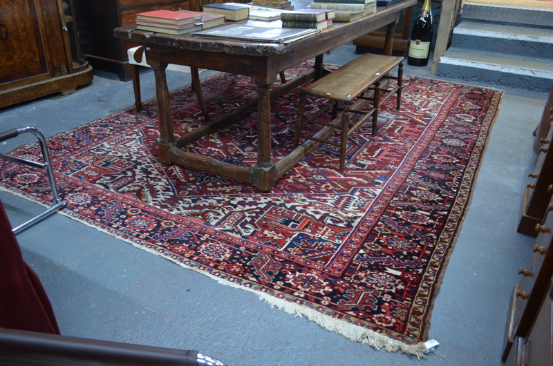 A Persian Heriz carpet, the large central blue medallion on red ground with stylised floral design, - Image 5 of 7