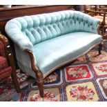 A Victorian carved walnut framed button back blue silk upholstered small salon sofa,