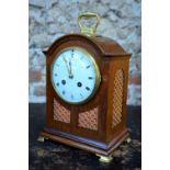 A French walnut cased 8-day mantel clock with white enamelled convex dial,