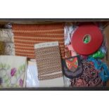 A box of assorted vintage braidings, ribbon, old school badges and other haberdashery,