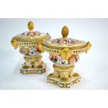A matched pair of early 19th century Derby Imari decorated pot pourri vases and covers,