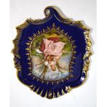 A 19th century Vienna porcelain shaped plaque painted to the centre in a shield shaped reserve with