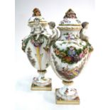 A pair of 19th century continental porcelain vases and covers, the handles in the form of putti,