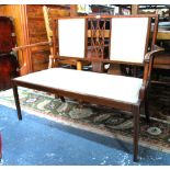 An Edwardian inlaid walnut framed two seater sofa in the Sheraton style,