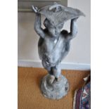 A cast lead figure of a cherub, supporting a sundial,