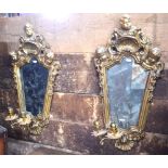 A companion pair of George II style composite cast girondelles with aged mirror plates and twin