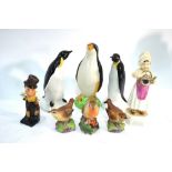 A small collection of ornaments comprising: Two Poole Pottery penguins, Avon Ware penguin,