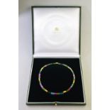 A choker necklace formed of vari-coloured tourmaline cylindrical beads having gilt metal beads