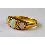 An opal three stone ring with four old cut diamonds between, 18ct yellow gold claw setting,