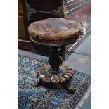 A Victorian rosewood piano stool with battered leather adjustable height seat