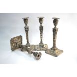 A set of four Edwardian loaded silver candlesticks in the Adam Revival manner,