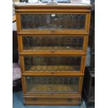 A Globe Wernicke golden oak four section library bookcase with lattice lead glazed doors,