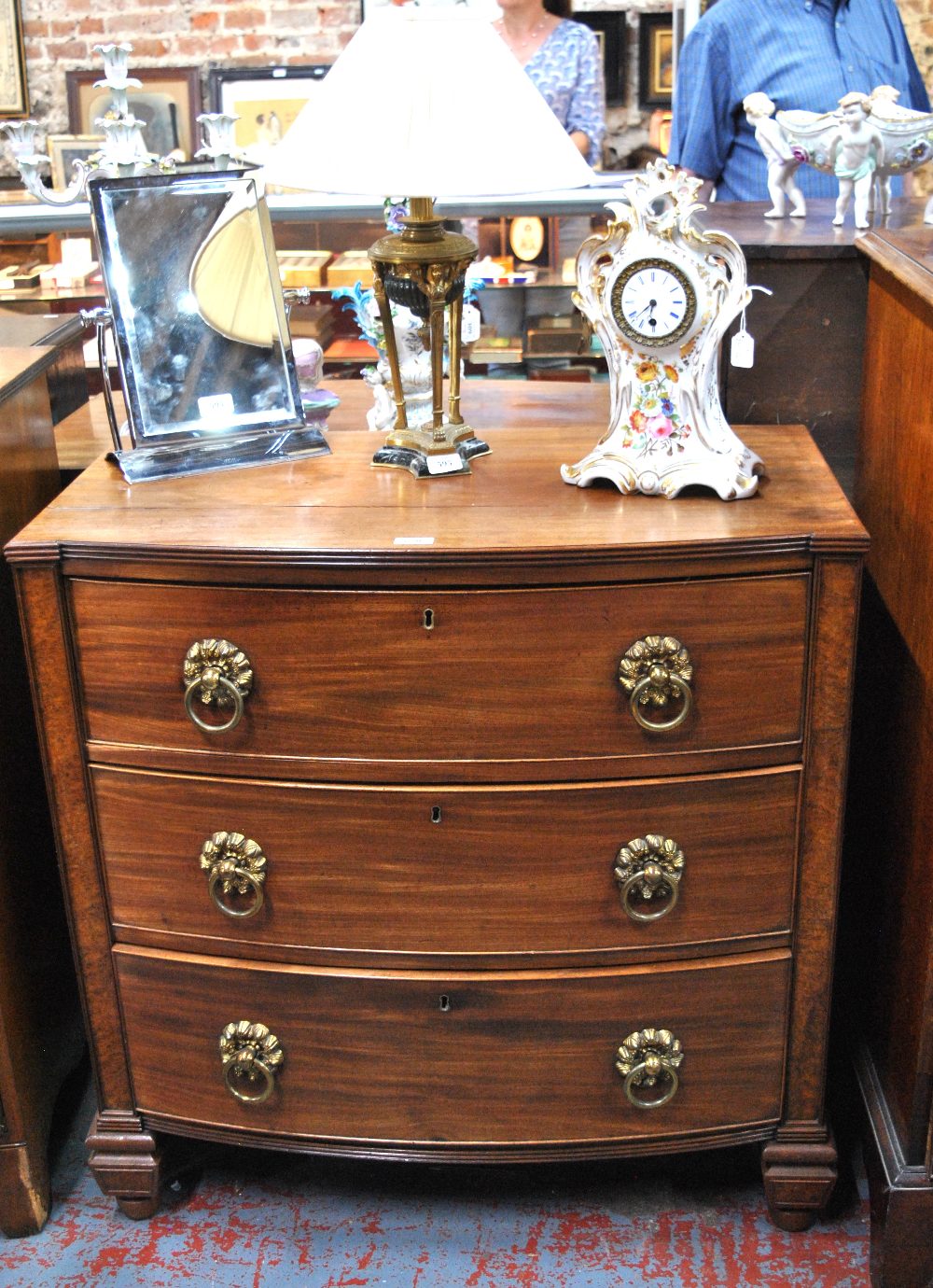 A 19th century mahogany bowfront chest of three long graduated drawers flanked by burr-oak veneered