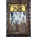 A small Regency gilt-framed pier glass with cornice tip and reeded pilasters,