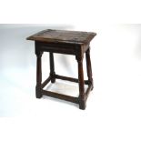 A 17th century oak joint stool, the single plank seat over lunette carved rails,