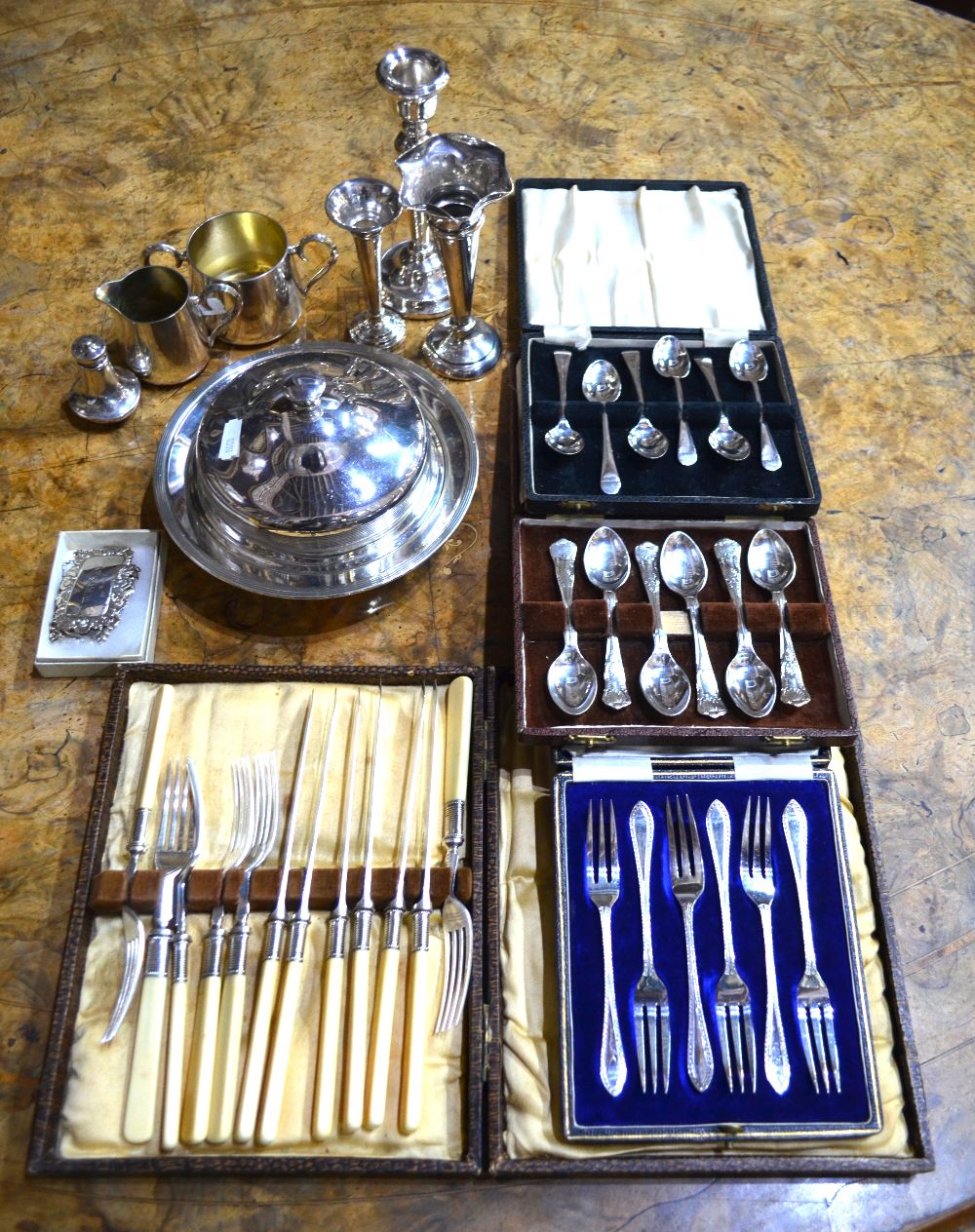 A cased set of six silver OEP coffee spoons, Sheffield 1933, a loaded silver baluster candlestick,