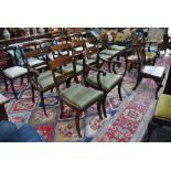 A set of eight Regency bar back mahogany dining chairs comprising six side and two carvers having