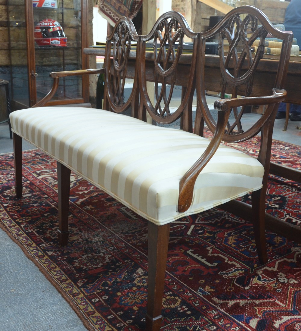 A 19th century Hepplewhite-style triple chair back settee,