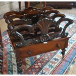 A Victorian rosewood Canterbury having four pierced and moulded divisions over a drawer,