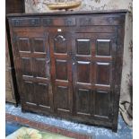 An early 18th century joined and panelled oak press cupboard,