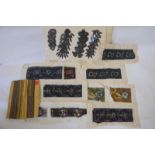 A collection of early 20th century haberdasher's embroidered samples, trimmings and embellishments,