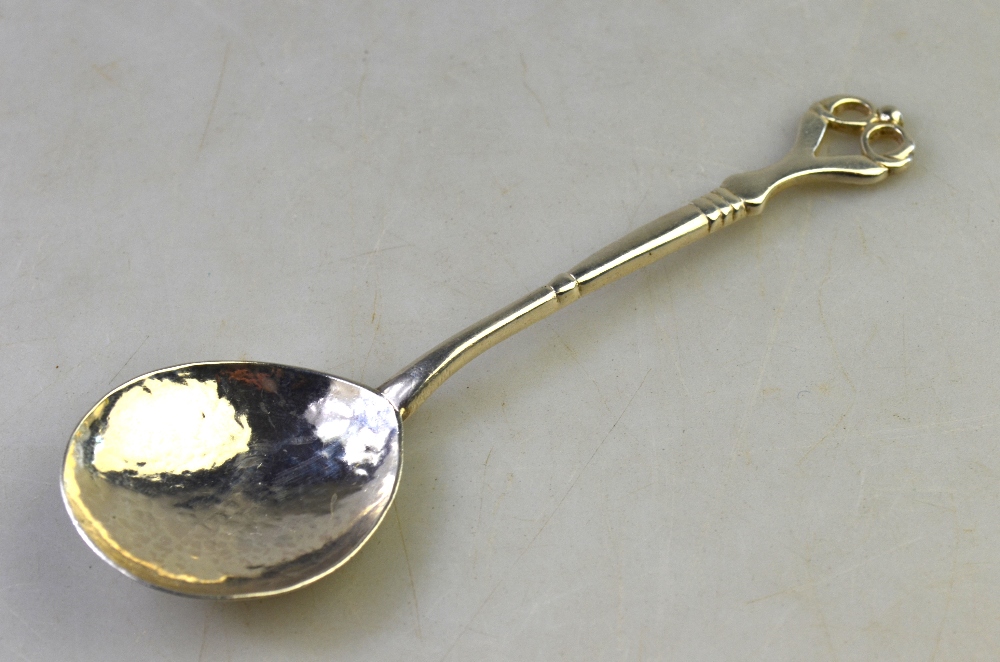 Winifred King: Art Nouveau style silver preserve spoon with scrolling whiplash finial and planished