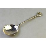 Winifred King: Art Nouveau style silver preserve spoon with scrolling whiplash finial and planished