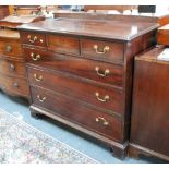 A George III mahogany chest of three short over three long graduated drawers raised on shaped