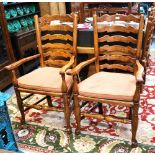 A set of ten 18th century style oak wavy ladderback dining chairs with rope seats comprising eight