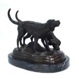 A brown bronze patinated study of a pair of dogs,