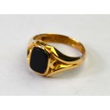 A 9ct yellow gold signet style ring set with rectangular onyx,