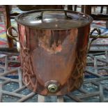 A large copper cylindrical kettle and cover with brass loop handles,