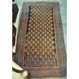 An old Persian Hamadan/Kurd rug, the repeating design with geometric designs on a dark blue ground,