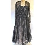 A 1950s black lace evening dress laid over shell-pink tulle under-skirt,