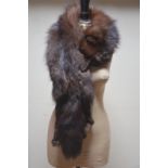 A dark brown fox fur with leg embellishment Condition Report Good condition