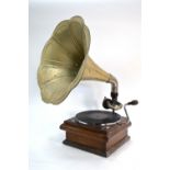 A wind-up gramophone with tin horn and oak case