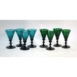 Two sets of four 19th century green drinking glasses, both having conical bowls,
