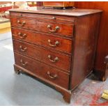 A George III mahogany chest of four long graduated drawers beneath a brush slide,